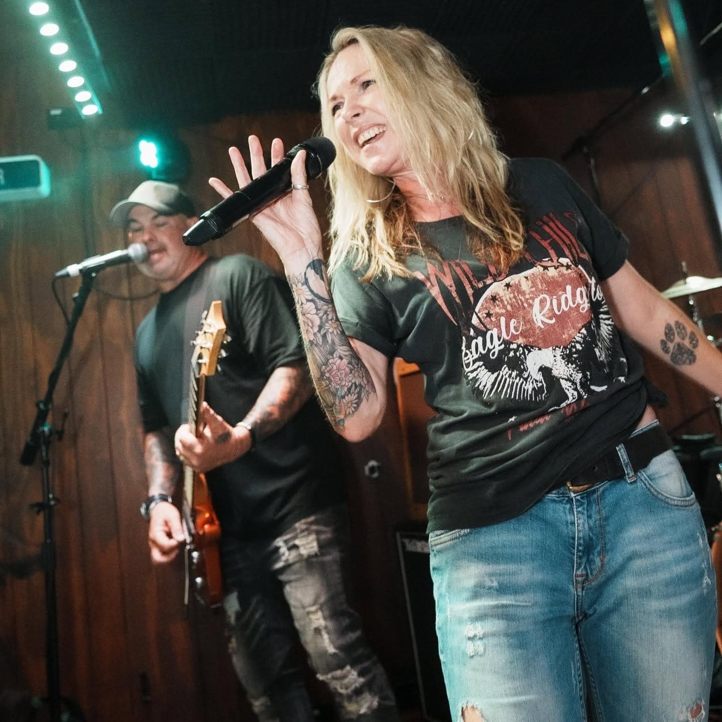 Singer belting out a song with the band behind her
