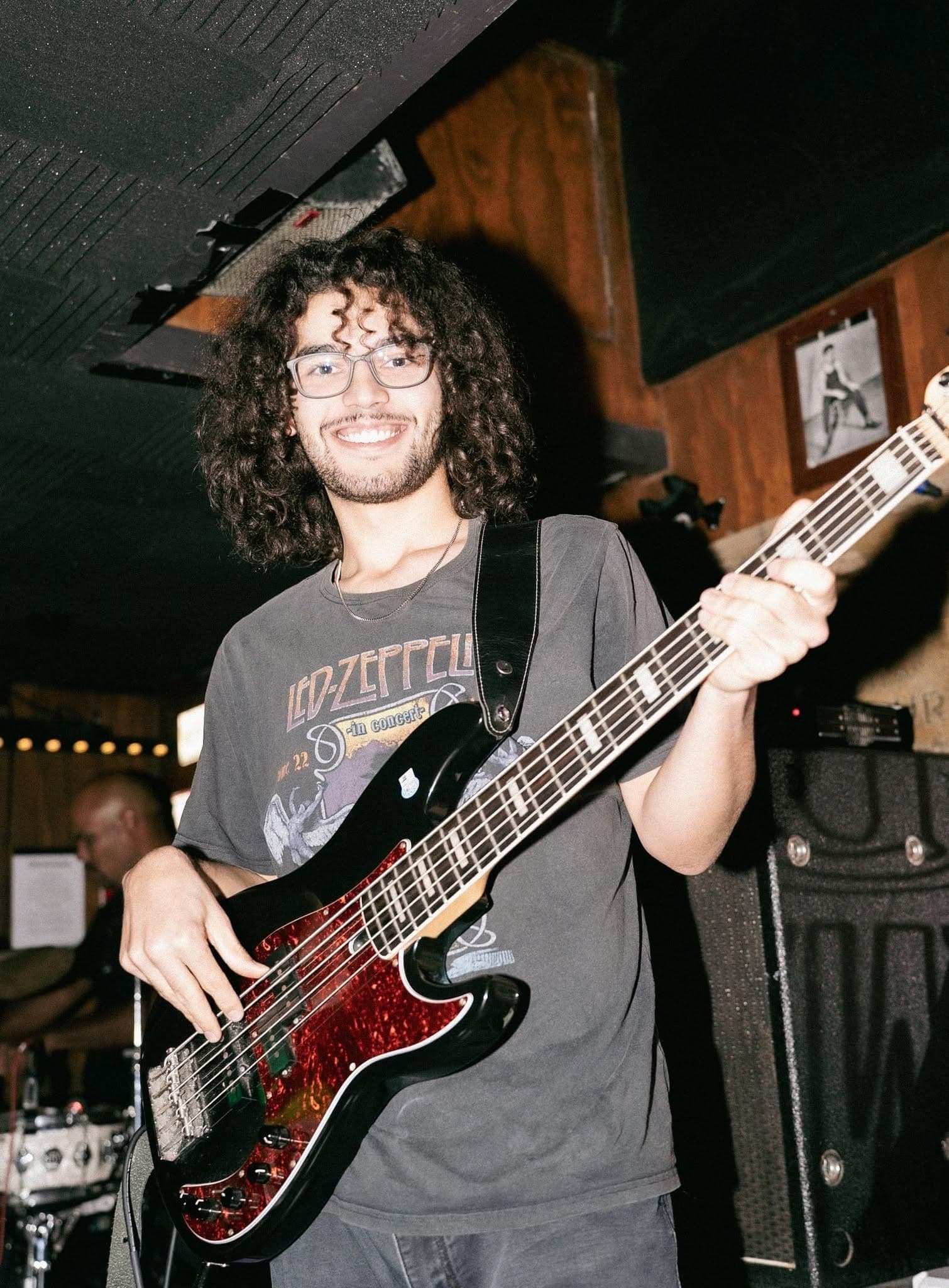 Bass player grinning on stage