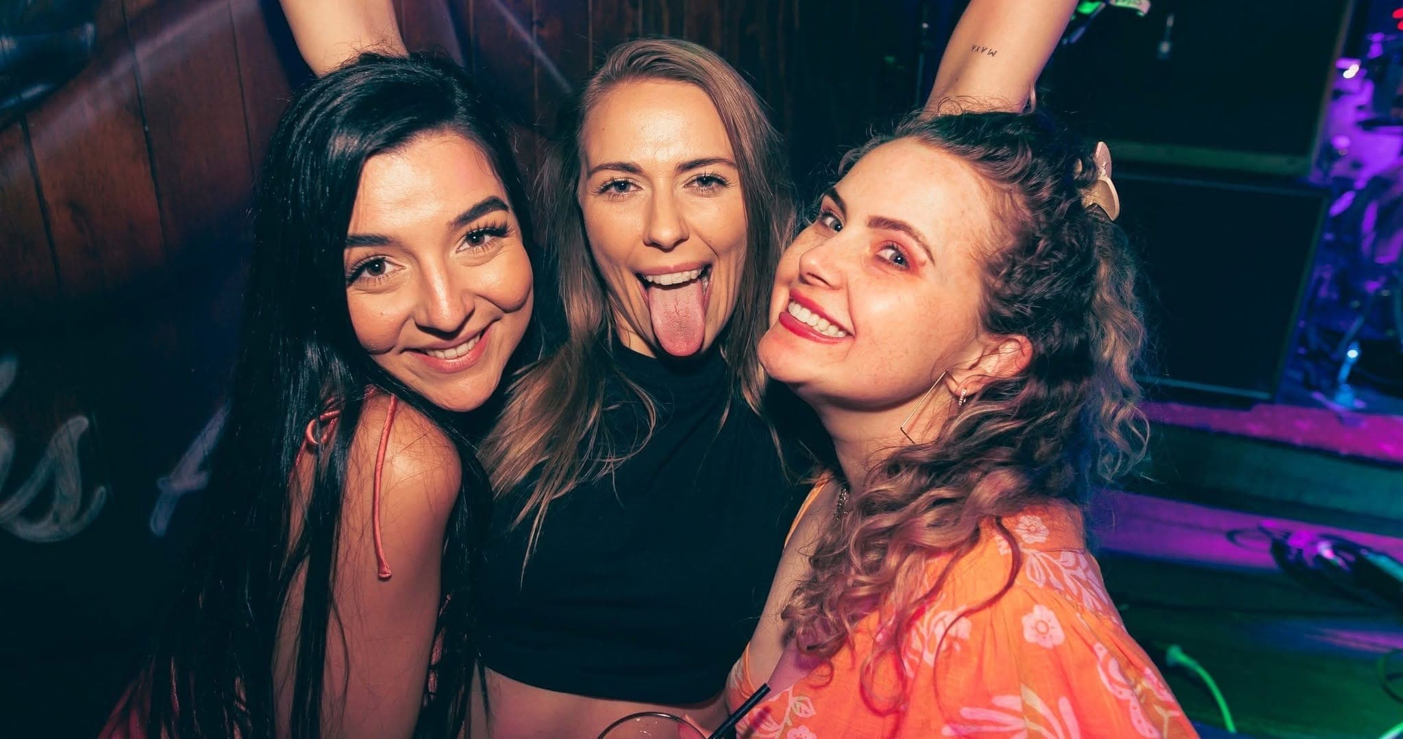 Three friends pulling faces for the camera