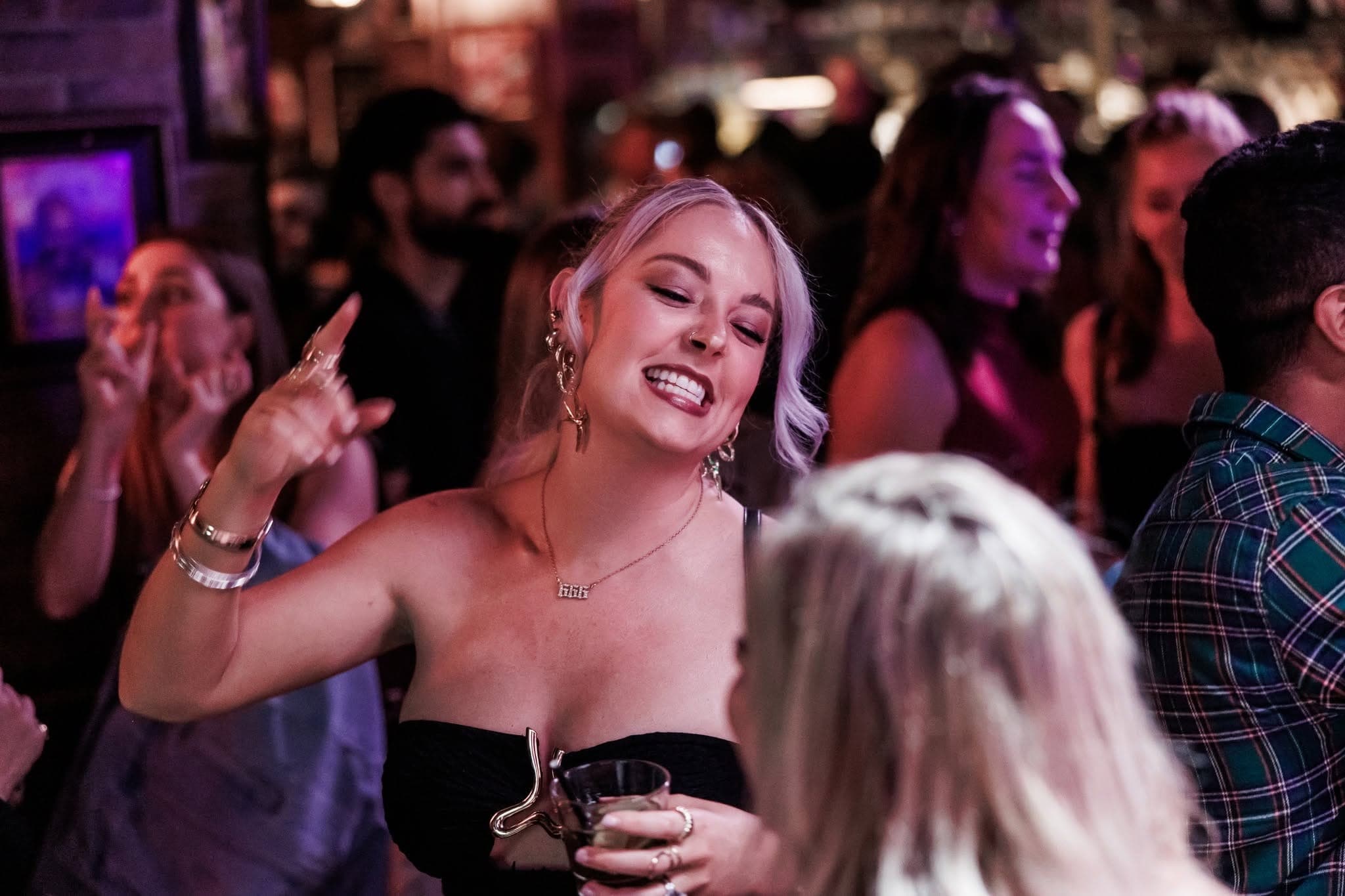 Woman dancing with a drink in hand