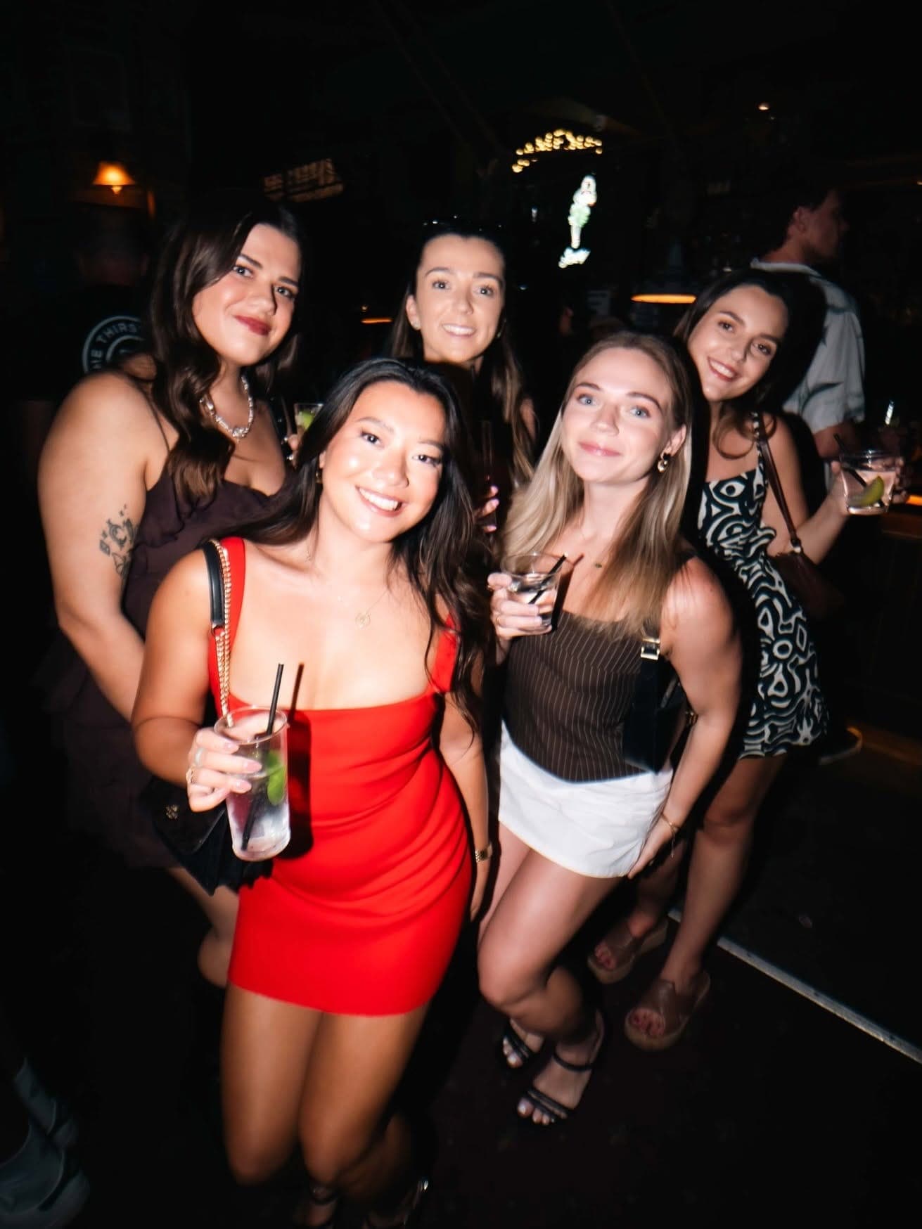 Group of friends in the crowd with drinks