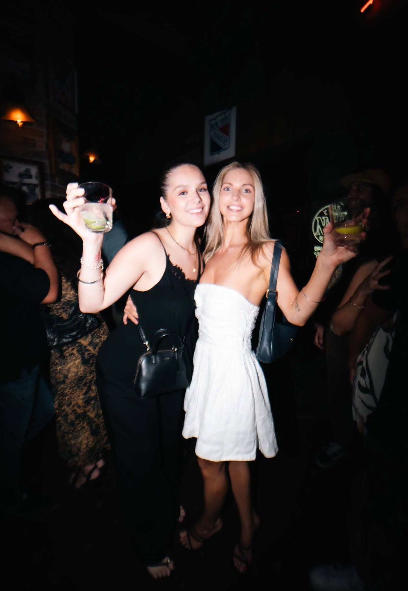 Friends dancing with drinks raised