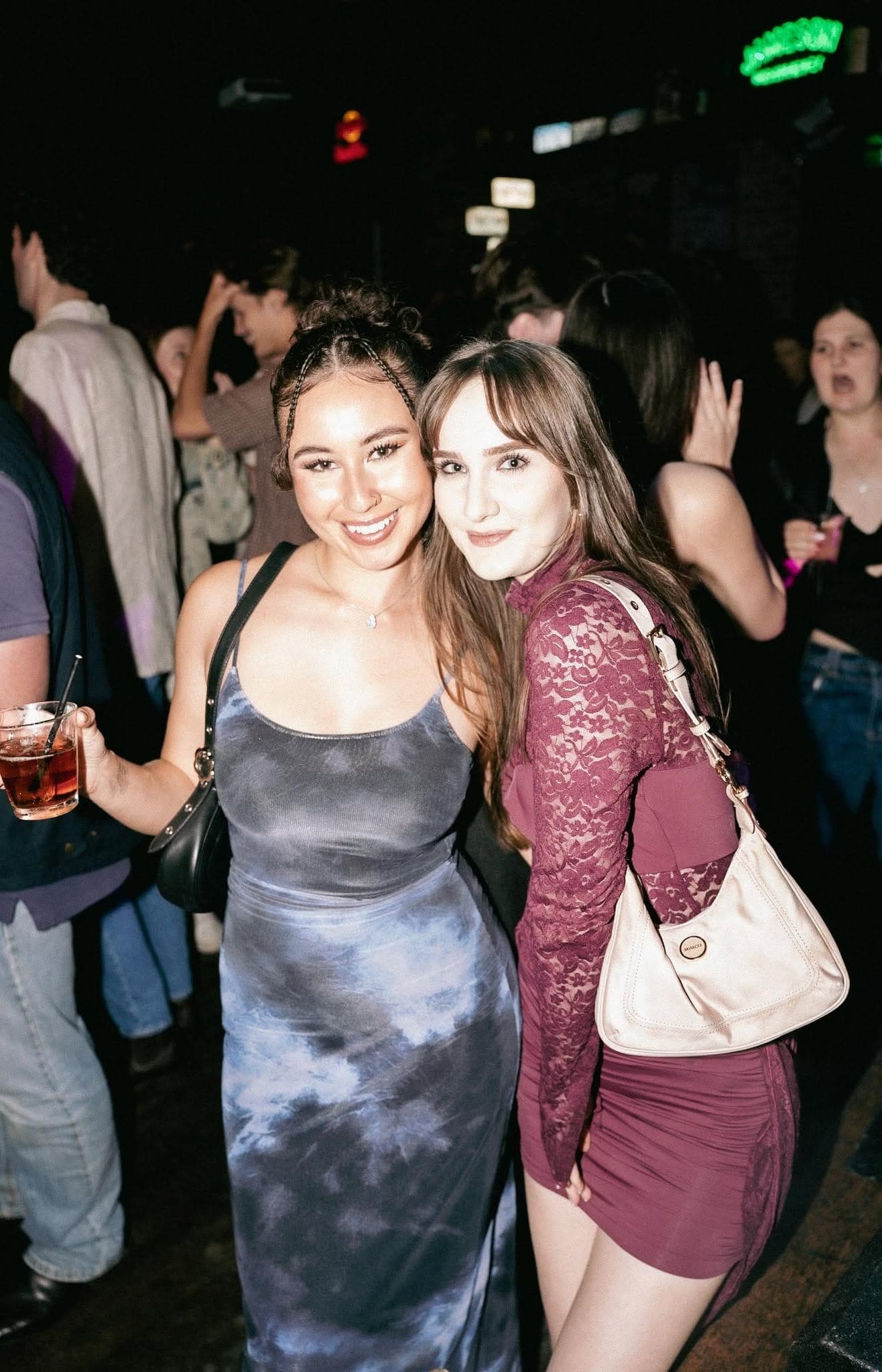 Two friends posing at the bar